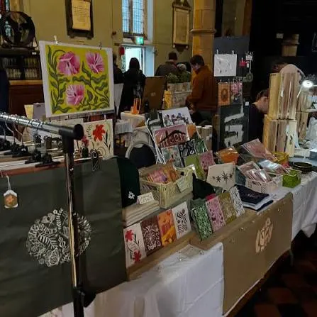 A stall of hand-printed cards, bags and prints