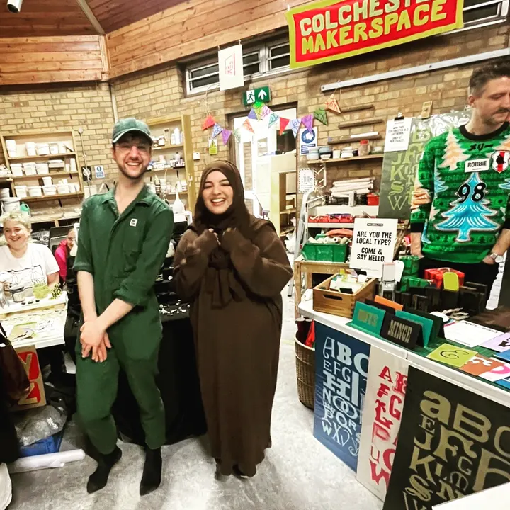Stallholders laughing under the Colchester Makerspace banner
